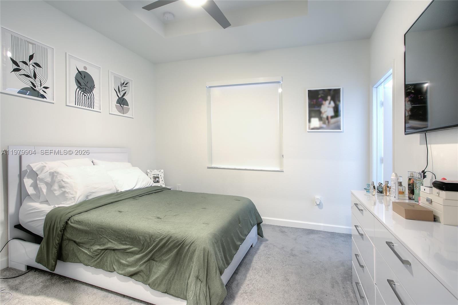 11849 Southwest 247th Terrace Homestead, FL 33032 - Photo 9 of 13 a bedroom with a bed and a flat screen tv