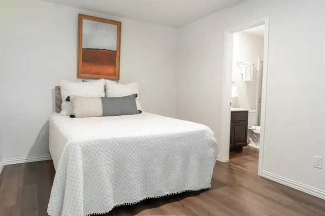 a bedroom with a bed and a mirror