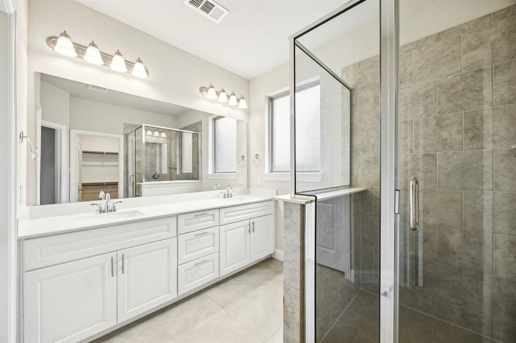 8081 Snowmass Drive Frisco, TX 75034 - Photo 13 of 25 a bathroom with a double vanity sink mirror and shower