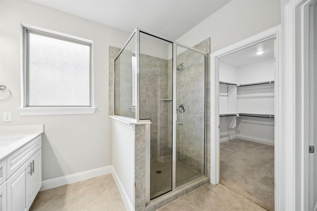 8081 Snowmass Drive Frisco, TX 75034 - Photo 15 of 25 a bathroom with a shower and a glass door