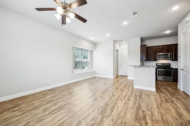 a view of kitchen with sink and wooden floor