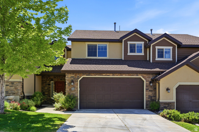 1614 Aspen Loop Provo, UT 84606 - Photo 1 of 47 Multi-level residence featuring a stone facade, stucco siding, and a prominent two-car garage
