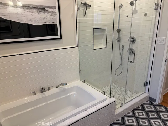 a bathroom with a bathtub and a shower