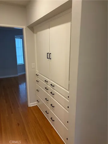 a view of walk in closet with empty racks