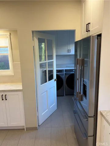 a kitchen with a refrigerator and a sink