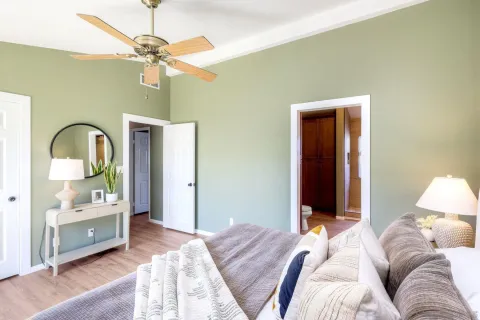 a bedroom with a bed and a chandelier