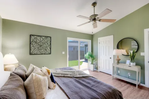 a bedroom with a bed couch and a window