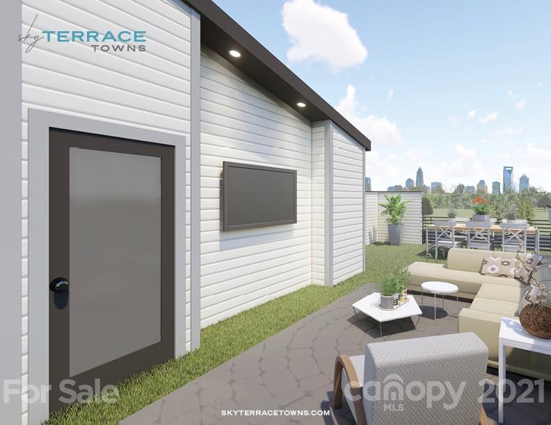 2335 Wesley Village Road, Unit 35 Charlotte, NC 28208 - Photo 20 of 28 a balcony with furniture and a fireplace