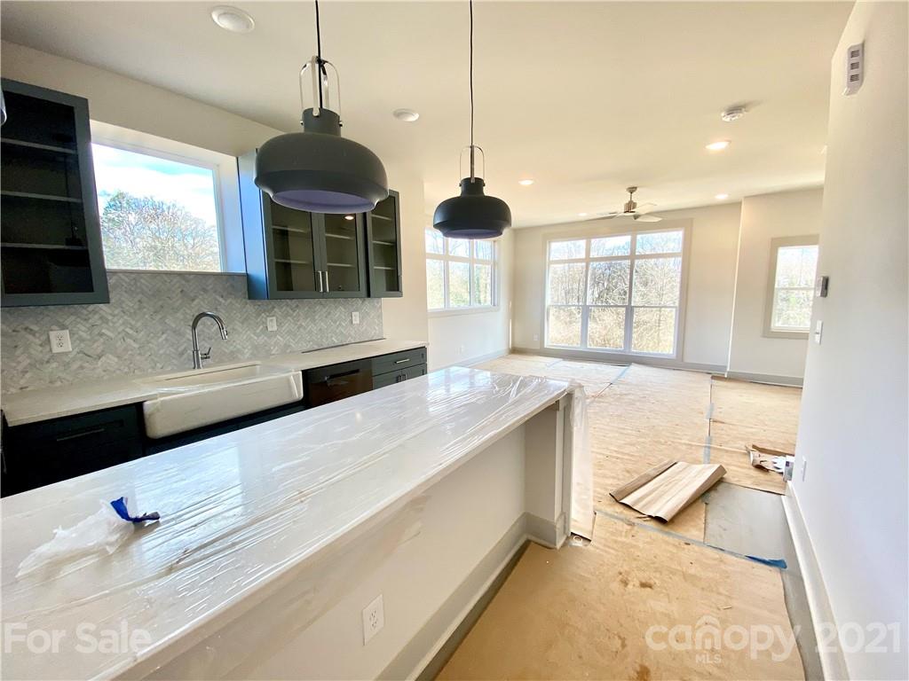 2335 Wesley Village Road, Unit 35 Charlotte, NC 28208 - Photo 25 of 28 a spacious bathroom with a granite countertop sink and a large mirror