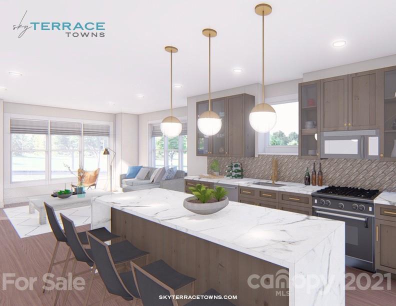 2335 Wesley Village Road, Unit 35 Charlotte, NC 28208 - Photo 9 of 28 a kitchen with a stove a kitchen island a dining table and chairs