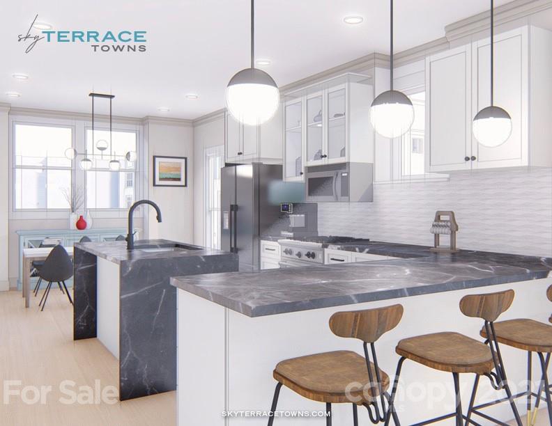2335 Wesley Village Road, Unit 35 Charlotte, NC 28208 - Photo 10 of 28 a kitchen with stainless steel appliances granite countertop a sink a stove and a wooden floors