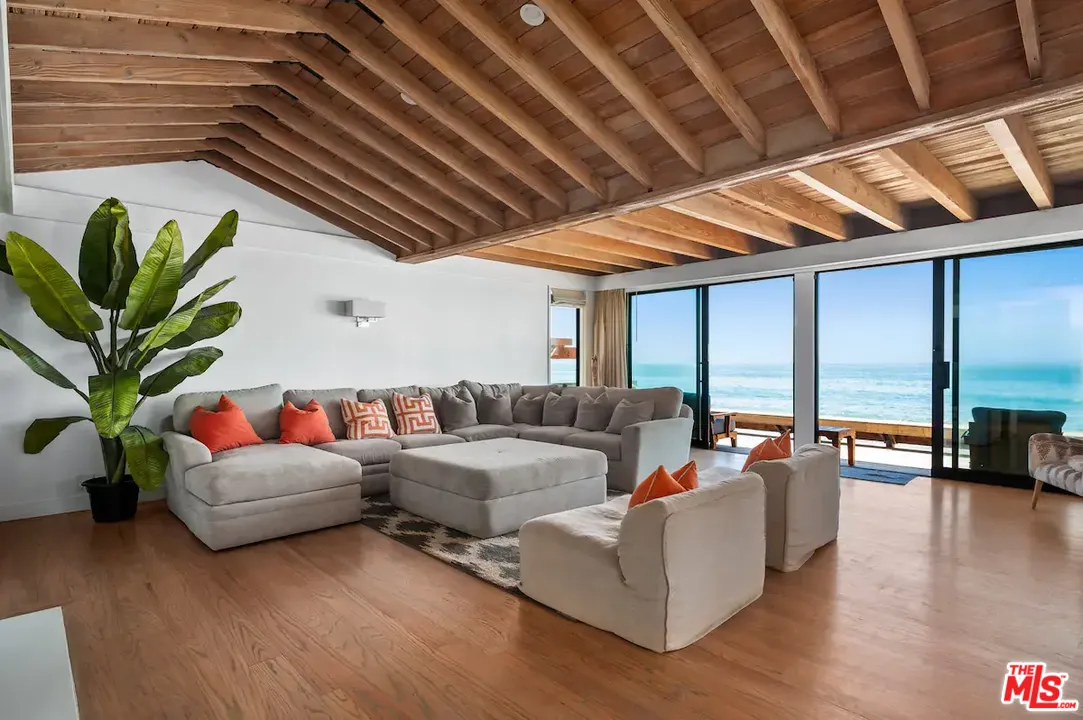 24608 Malibu Road Malibu, CA 90265 - Photo 14 of 30 a living room with furniture floor to ceiling window and wooden floor