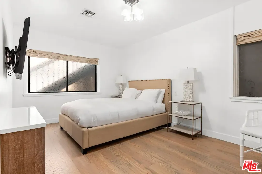 24608 Malibu Road Malibu, CA 90265 - Photo 15 of 30 a bedroom with a bed window and dresser