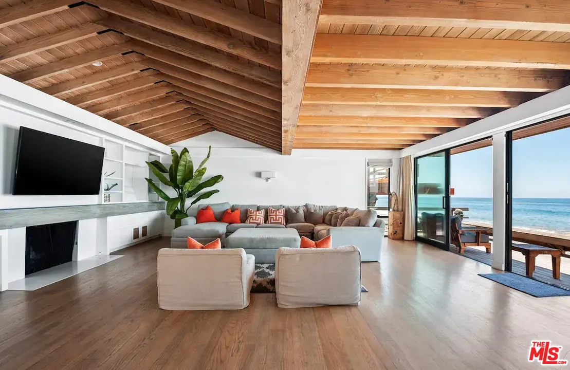 24608 Malibu Road Malibu, CA 90265 - Photo 19 of 30 a living room with furniture and a flat screen tv