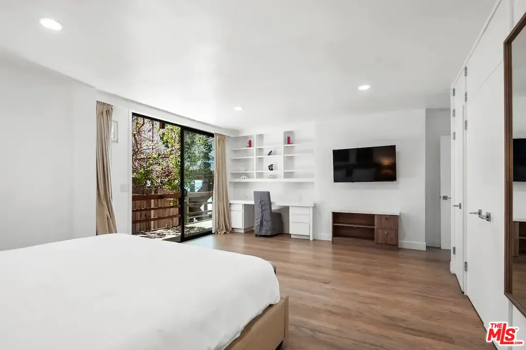 24608 Malibu Road Malibu, CA 90265 - Photo 6 of 30 a bedroom with a large bed and a flat screen tv