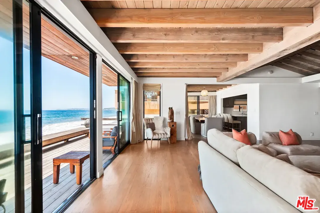 24608 Malibu Road Malibu, CA 90265 - Photo 8 of 30 a hallway with a large dining table and chairs