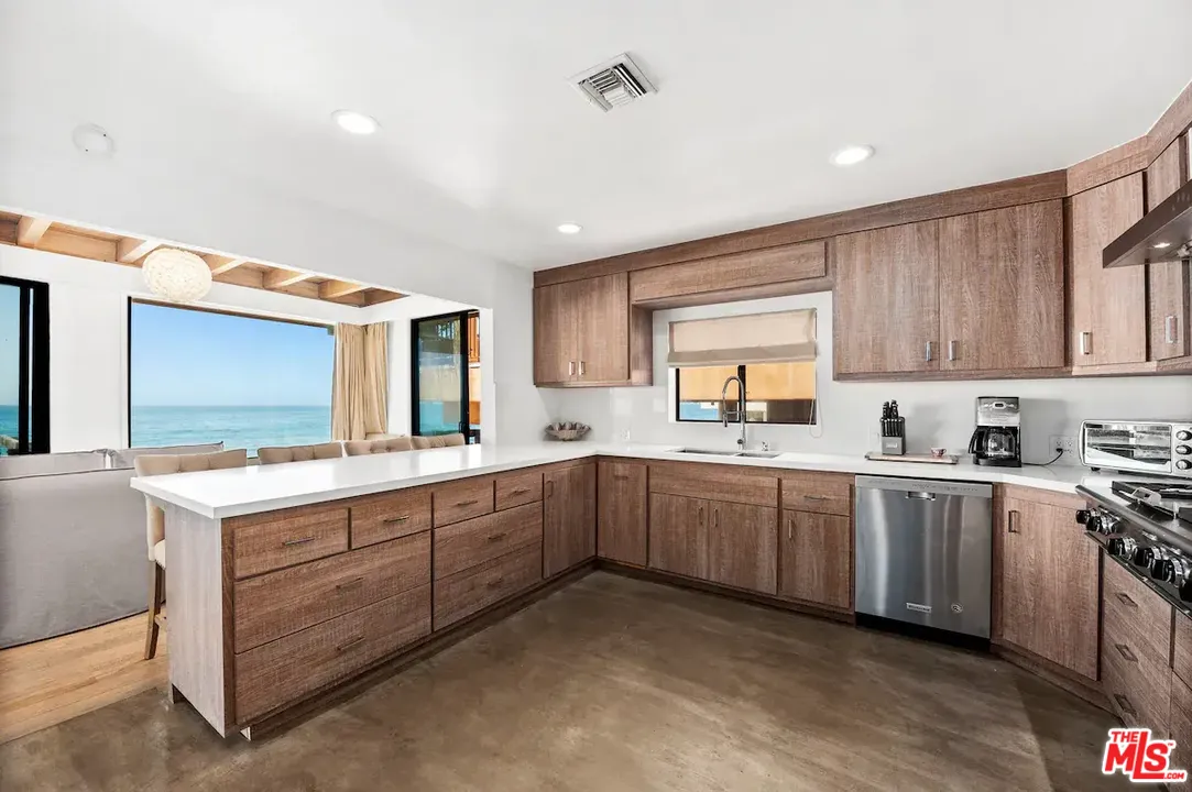 24608 Malibu Road Malibu, CA 90265 - Photo 9 of 30 a kitchen with sink cabinets and window