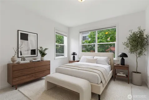 a bedroom with a bed and a large window