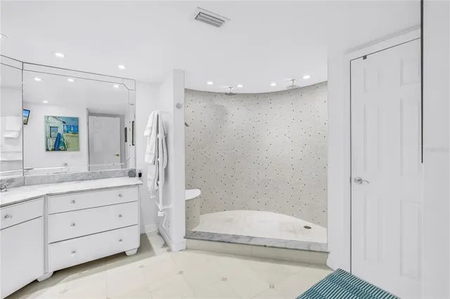 a bedroom with two beds and painting on the wall