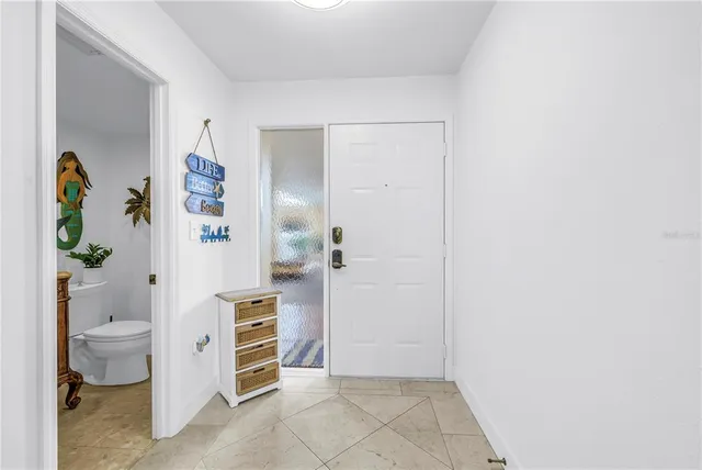 a bathroom with a granite countertop double vanity and a large mirror