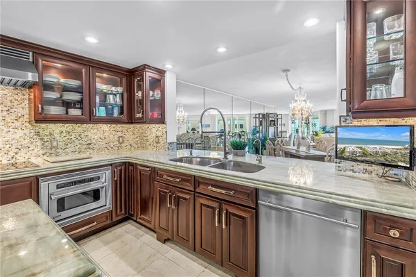 a kitchen with a table chairs and a refrigerator