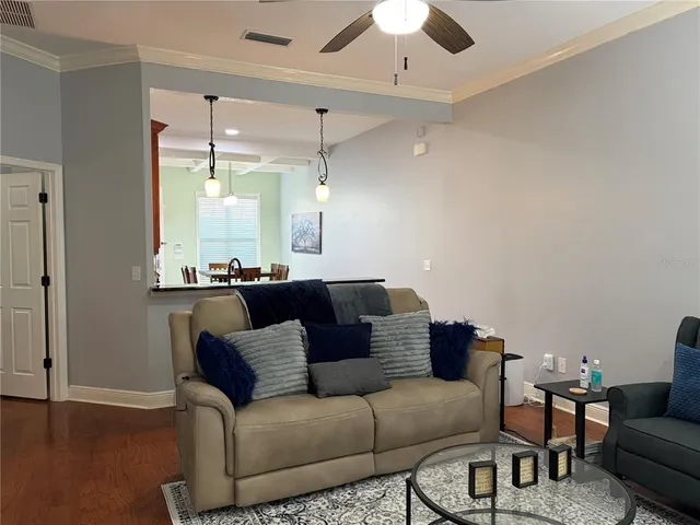 a kitchen with a table chairs and refrigerator