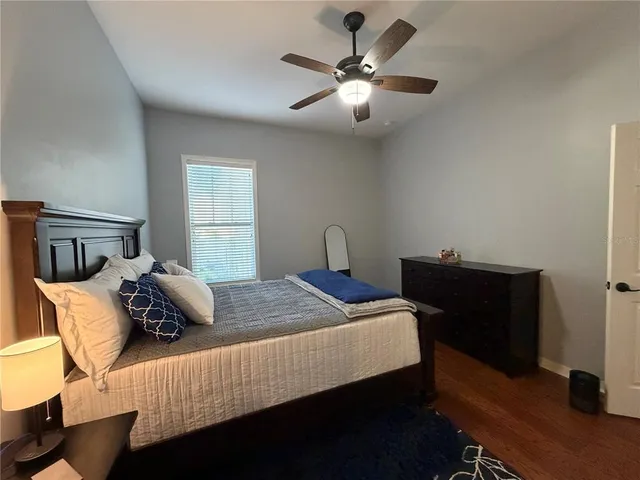 a bedroom with bed and a chandelier