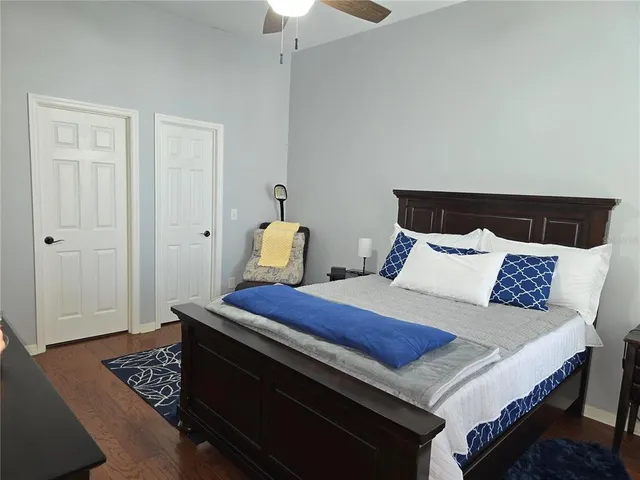 a bedroom with a bed and wooden floor