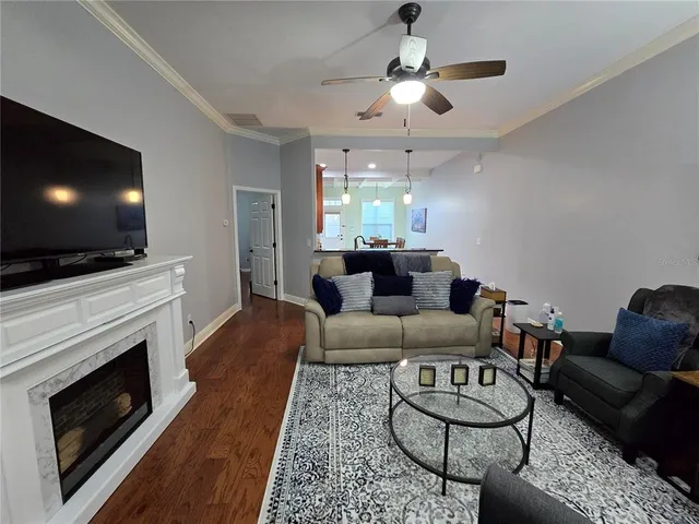 a living room with furniture a rug and a chandelier