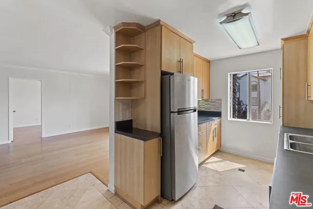 a kitchen with a refrigerator and cabinets