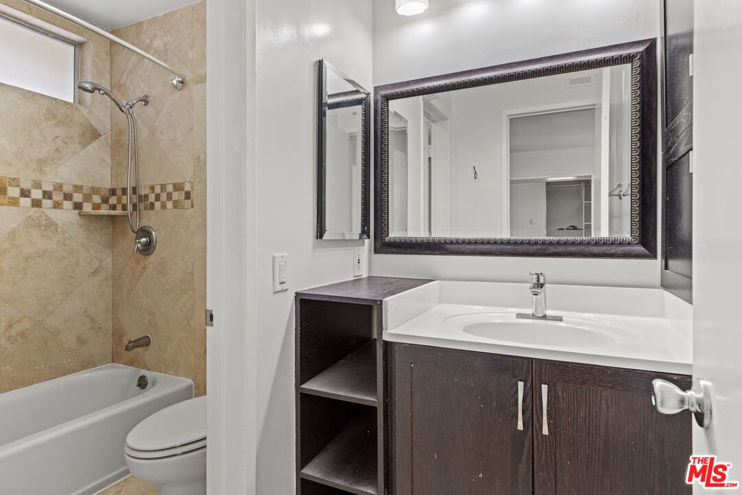 1033 6th Street, Unit 212 Santa Monica, CA 90403 - Photo 5 of 18 a bathroom with a sink and a mirror