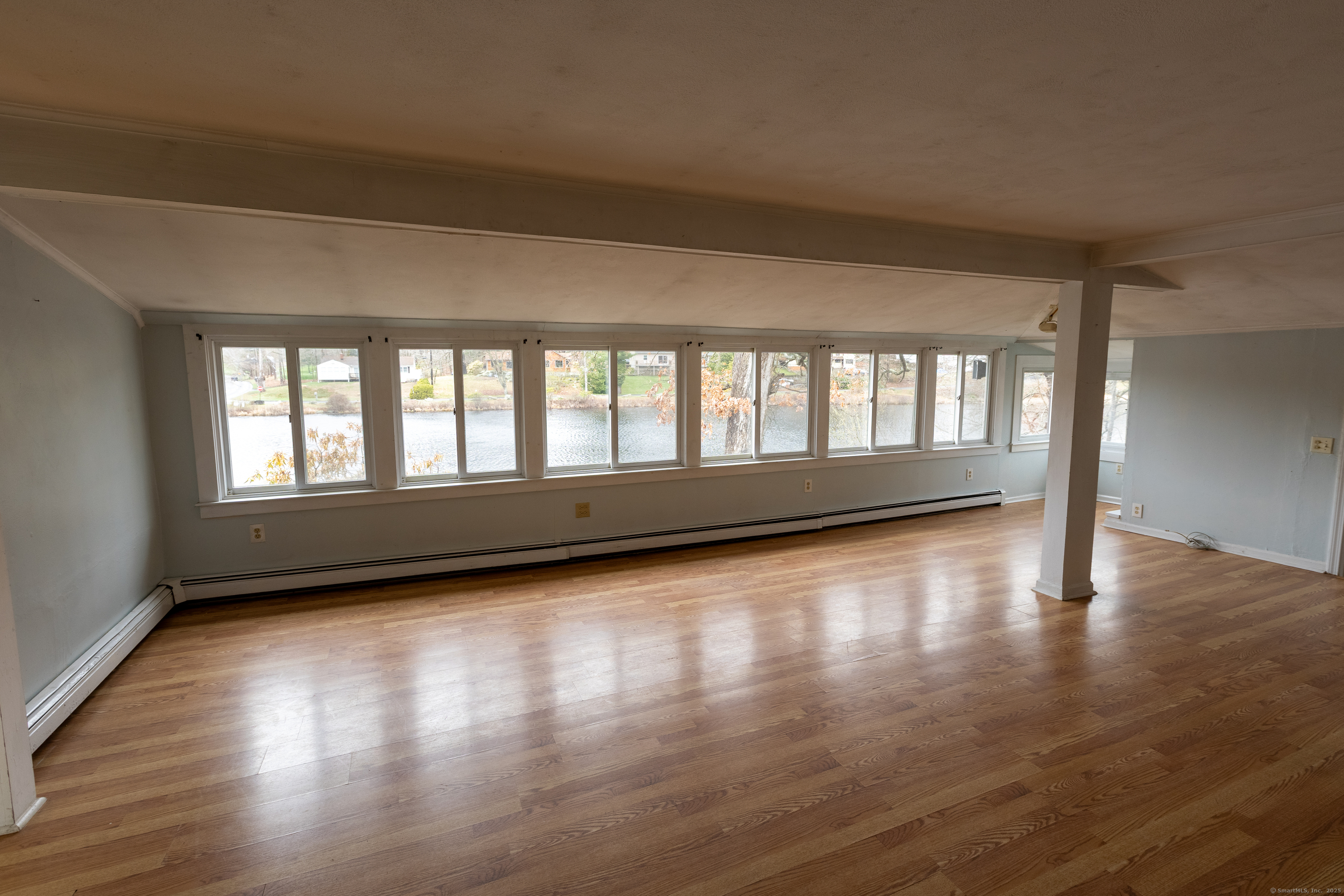 24 Echo Point Road Guilford, CT 06437 - Photo 14 of 30 a view of an empty room with wooden floor and a window