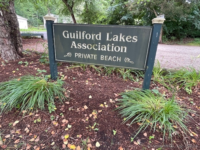 24 Echo Point Road Guilford, CT 06437 - Photo 21 of 30 a sign broad in front of the red tree