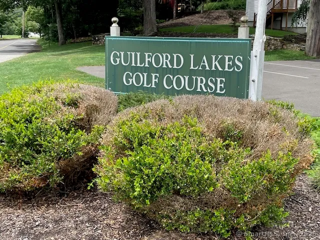 a sign broad in front of red brick house