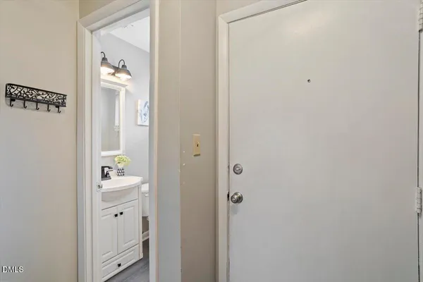 a bathroom with a sink mirror vanity and toilet