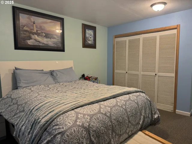 a bedroom with a bed and wall painting