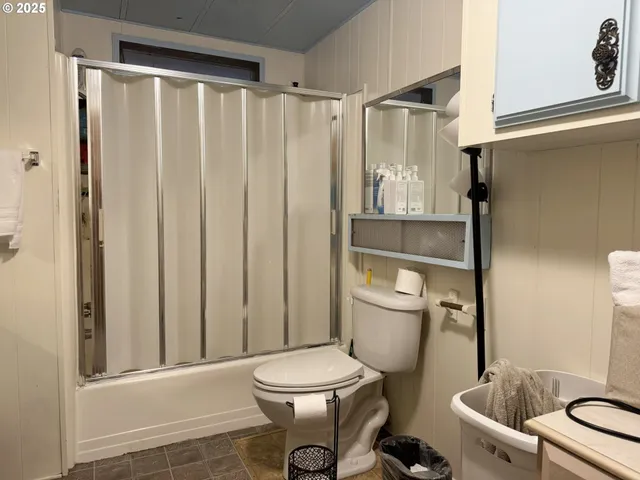 a white toilet sitting next to a bathroom sink