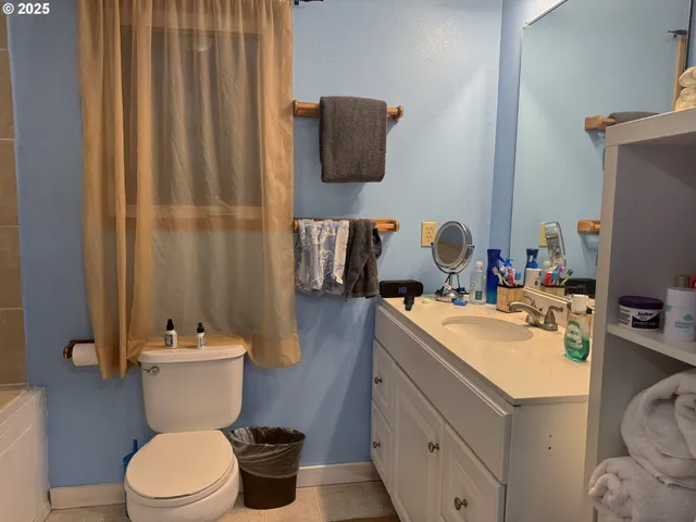 a bathroom with a sink vanity mirror and toilet
