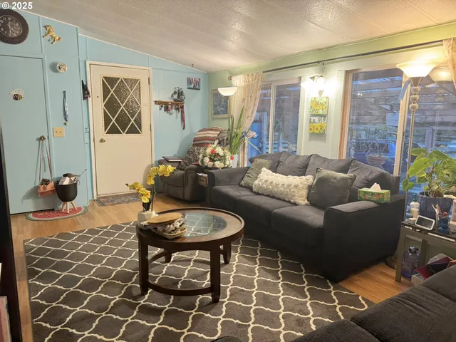 a living room with furniture a table and a painting on the wall