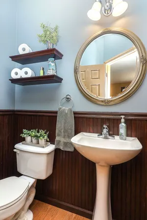 a bathroom with a sink mirror and toilet