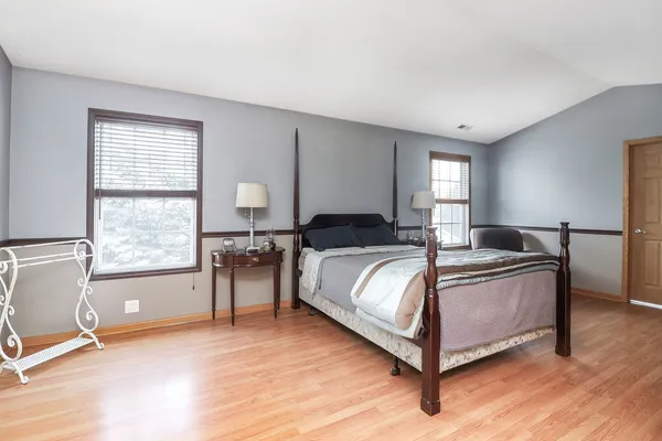 a spacious bedroom with a bed and window