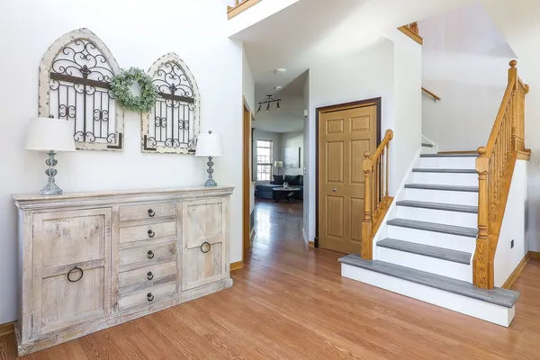 a view of entryway and hall with wooden floor