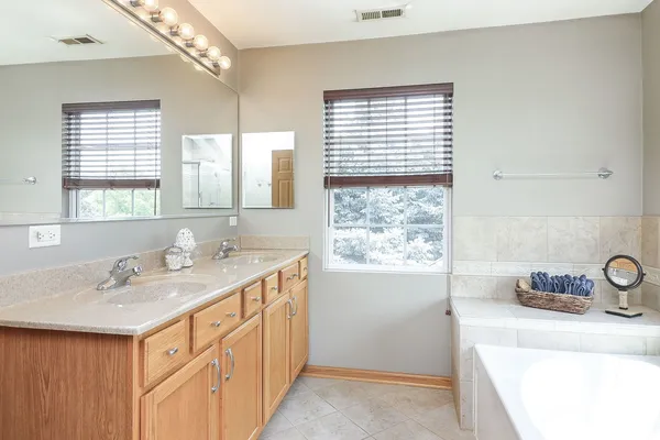 a bathroom with a sink double vanity and a tub