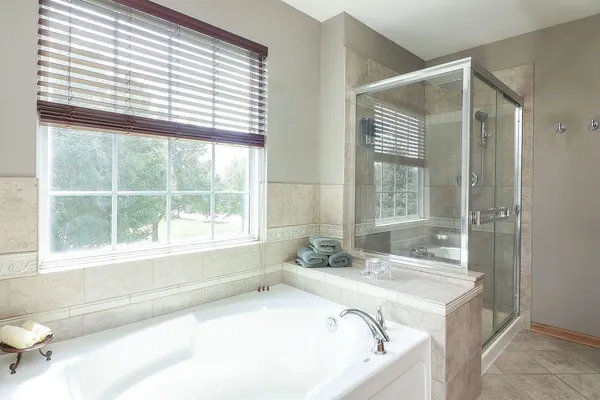 a bath tub sitting in a bathroom next to a window