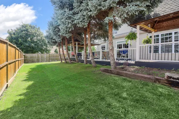 a view of a house with a yard and a patio