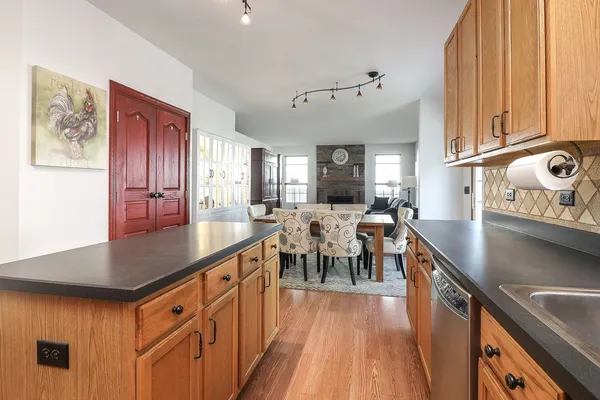 a kitchen with stainless steel appliances granite countertop a sink a stove and refrigerator