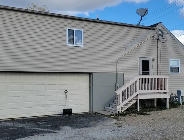 an aerial view of a house with garden space and sitting area