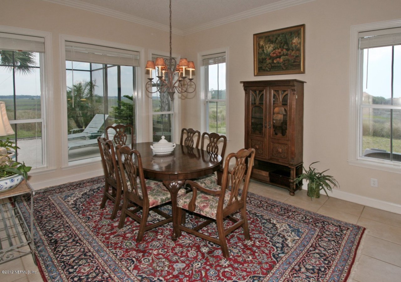 349 Fiddlers Point Drive St. Augustine, FL 32080 - Photo 13 of 27 a view of a dining room with furniture window and wooden floor