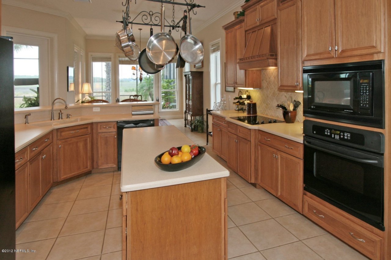 349 Fiddlers Point Drive St. Augustine, FL 32080 - Photo 14 of 27 a kitchen with a sink and wooden cabinets