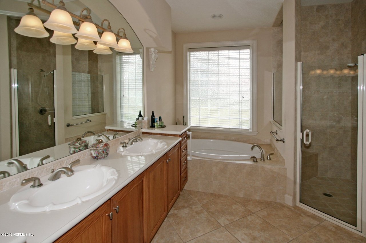 349 Fiddlers Point Drive St. Augustine, FL 32080 - Photo 18 of 27 a spacious bathroom with a tub sink and mirror